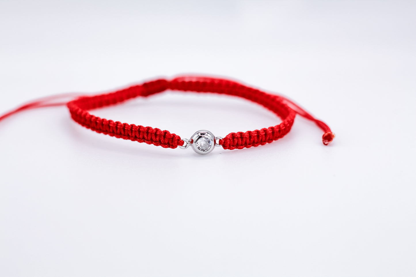 Bracelet on a red thread with a Zirconia stone